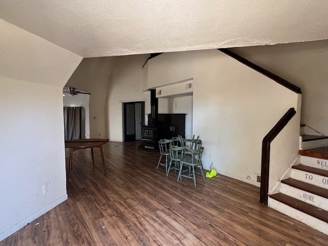 2508 22nd St, Snyder, TX 79549 - living room with a ceiling fan, a textured ceiling, wood finished floors, stairway, and lofted ceiling