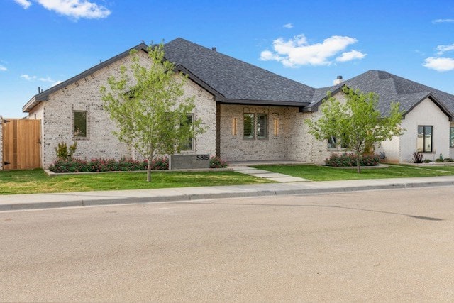 french provincial home with a front yard