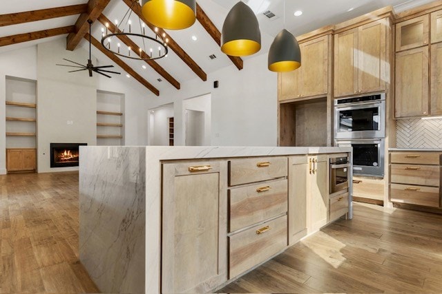 kitchen featuring double oven, light hardwood / wood-style flooring, beamed ceiling, and light brown cabinets