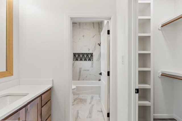 full bathroom with toilet, vanity, built in features, and tiled shower / bath combo