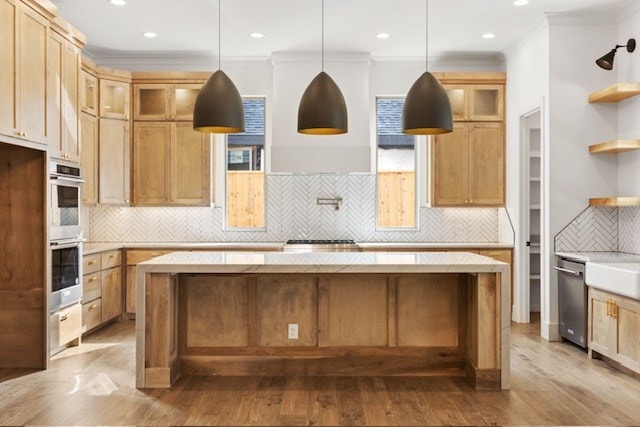 kitchen with light hardwood / wood-style floors, crown molding, and tasteful backsplash