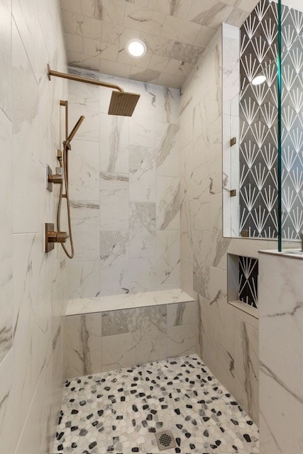 bathroom with a tile shower