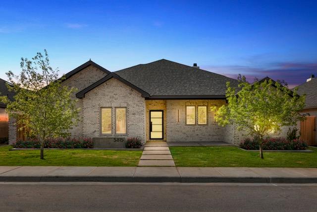 view of front of property with a yard