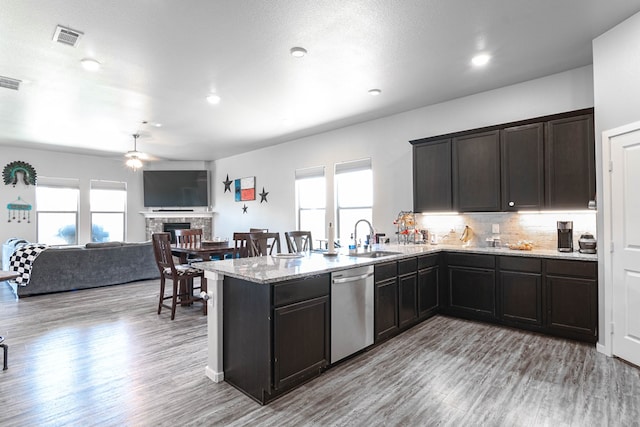 1407 Derrick Ave, Odessa, TX 79765 - kitchen featuring stainless steel dishwasher, ceiling fan, light wood-type flooring, a sink, and a peninsula