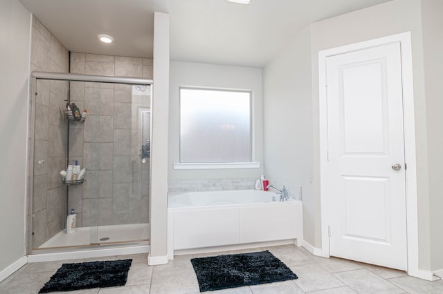 1407 Derrick Ave, Odessa, TX 79765 - bathroom with a garden tub, a stall shower, tile patterned floors, and baseboards