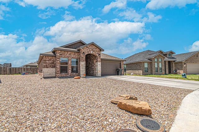 1407 Derrick Ave, Odessa, TX 79765 - view of front of home with brick siding, concrete driveway, and a garage