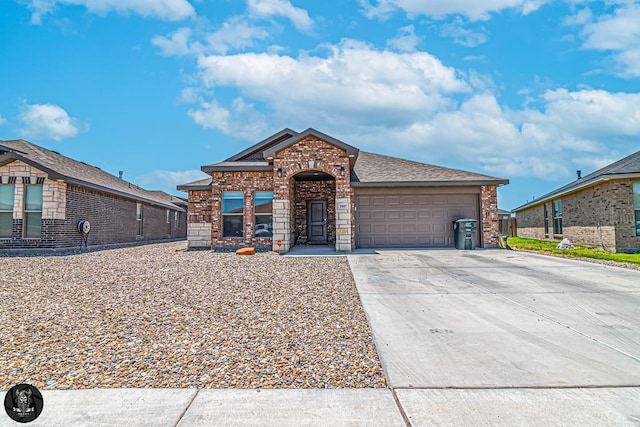 1407 Derrick Ave, Odessa, TX 79765 - view of front of property with an attached garage, brick siding, and concrete driveway