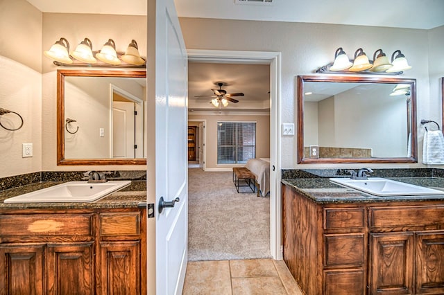 bathroom featuring ceiling fan, tile patterned floors, and vanity