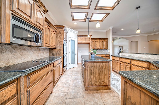 kitchen featuring crown molding, stainless steel appliances, backsplash, and hanging light fixtures