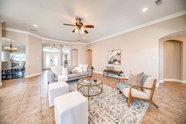 living room with ceiling fan with notable chandelier and crown molding