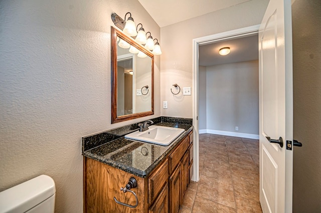 bathroom featuring toilet and vanity