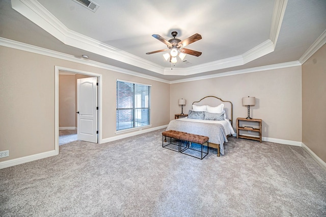 bedroom with crown molding, ceiling fan, a tray ceiling, and light carpet