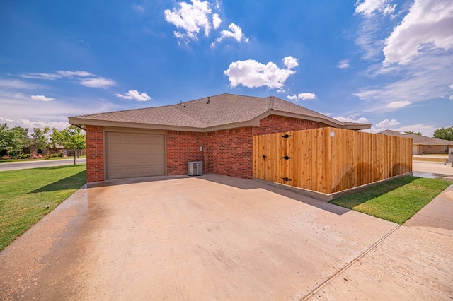 view of property exterior featuring cooling unit and a garage