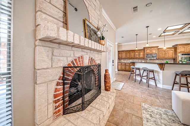 living room with a brick fireplace and crown molding