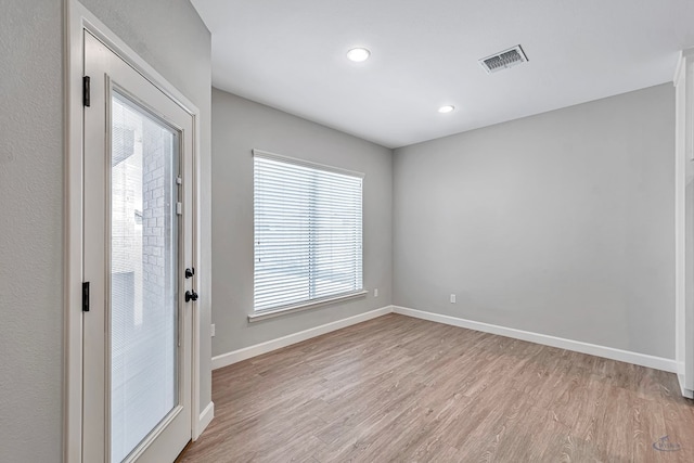 unfurnished room featuring light hardwood / wood-style flooring