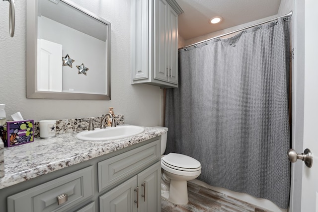 bathroom featuring hardwood / wood-style floors, toilet, and vanity