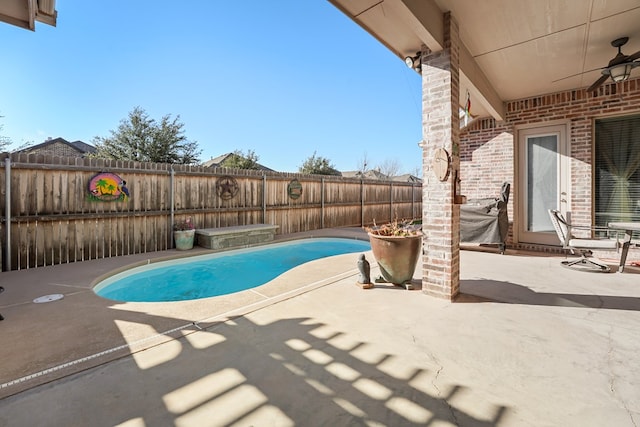 view of swimming pool featuring ceiling fan and a patio