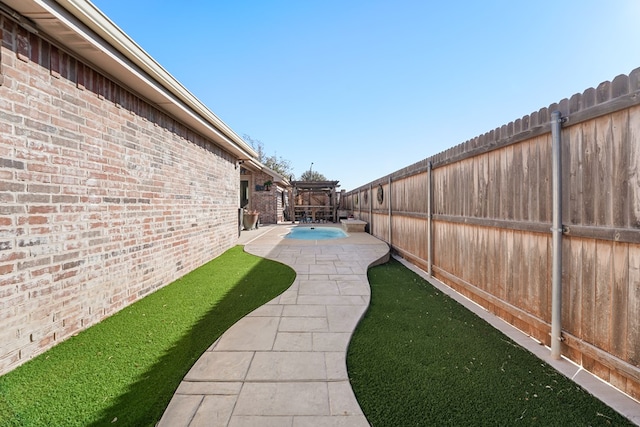 view of yard featuring a fenced in pool, a patio, and a pergola