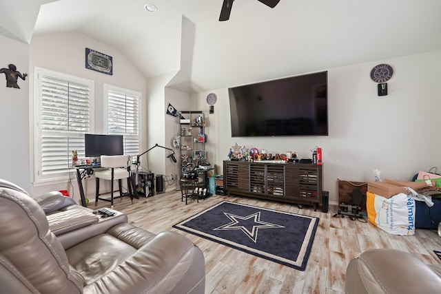 living room with ceiling fan, light hardwood / wood-style floors, and lofted ceiling