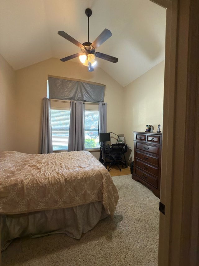 carpeted bedroom with vaulted ceiling and ceiling fan