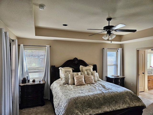 bedroom with multiple windows, ceiling fan, and light carpet