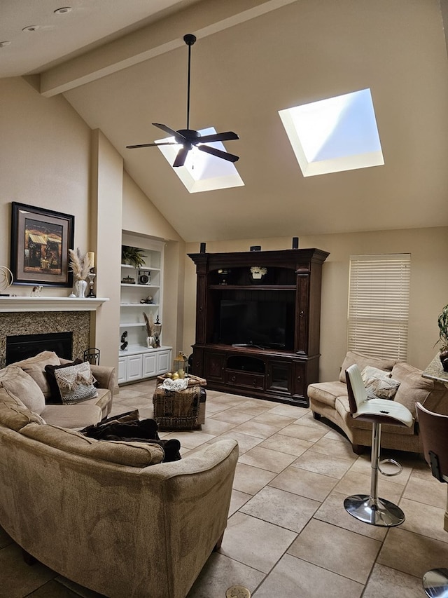 living room featuring vaulted ceiling with beams, ceiling fan, built in shelves, and a high end fireplace