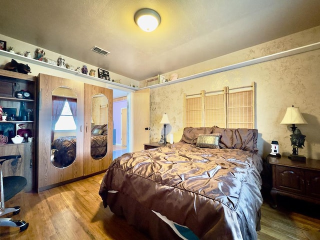 bedroom with hardwood / wood-style flooring