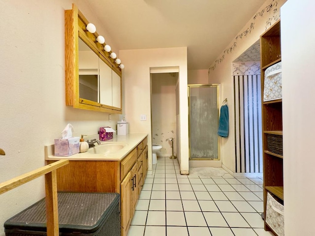 bathroom featuring tile patterned flooring, vanity, and a shower with shower door