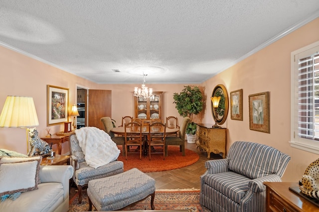 living room with parquet floors, a chandelier, a textured ceiling, and ornamental molding