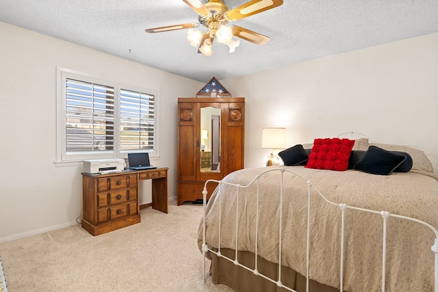 bedroom featuring light carpet, a textured ceiling, and ceiling fan