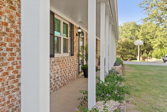 view of home's exterior featuring a porch and a yard