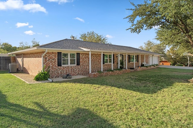 ranch-style home featuring a front lawn and central air condition unit