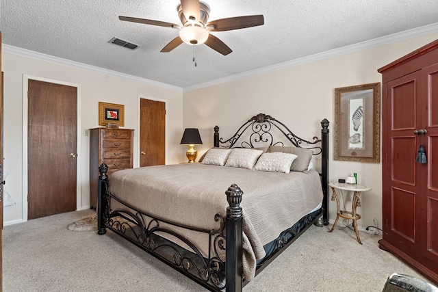 bedroom featuring ceiling fan, light colored carpet, ornamental molding, and a textured ceiling