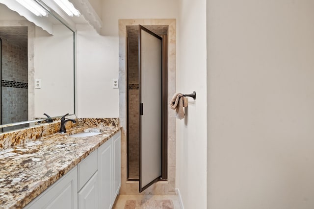 bathroom with tile patterned flooring, vanity, and a shower with shower door