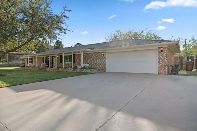 single story home featuring a garage and a front yard