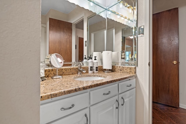 bathroom with vanity and parquet flooring