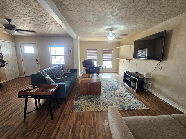 living area featuring a ceiling fan, a textured ceiling, a healthy amount of sunlight, and wood finished floors