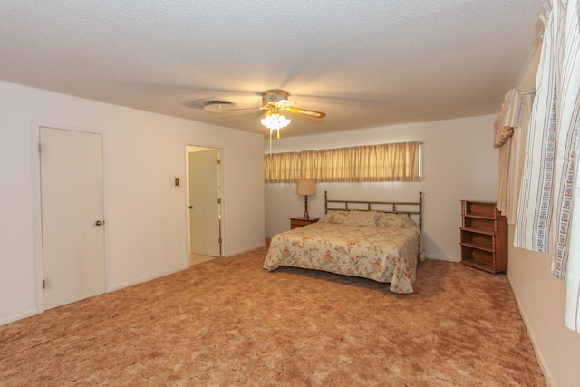 bedroom featuring ceiling fan, carpet floors, and a textured ceiling