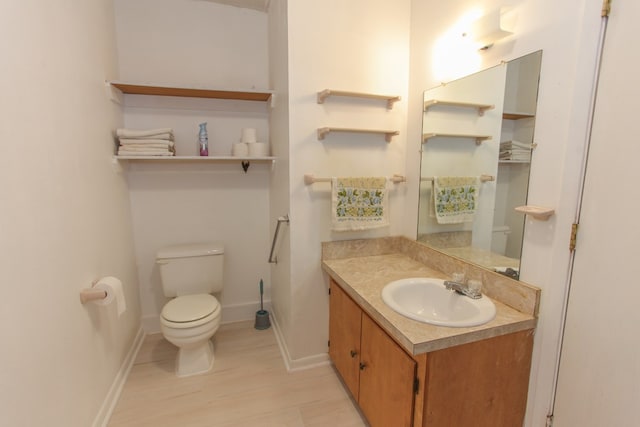 bathroom featuring hardwood / wood-style flooring, vanity, and toilet