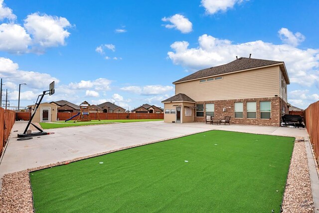 5700 San Miguel Ave, Midland, TX 79705 - rear view of property with a putting green, a playground, a patio area, and brick siding