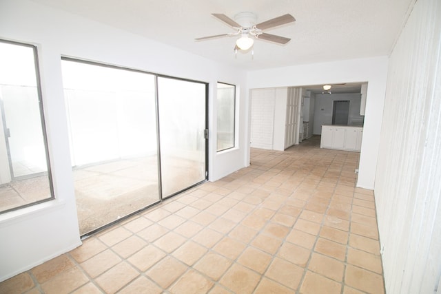 unfurnished bedroom featuring ceiling fan and light tile patterned floors