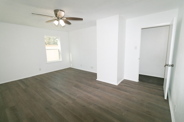 empty room with ceiling fan, dark hardwood / wood-style flooring, and a textured ceiling