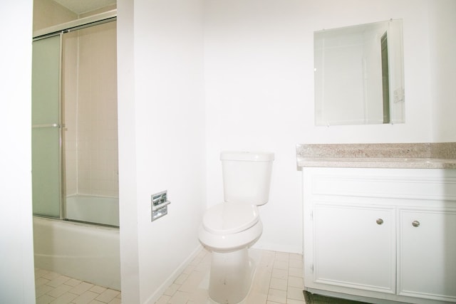 full bathroom with shower / bath combination with glass door, tile patterned floors, vanity, and toilet