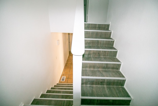 stairway with tile patterned flooring