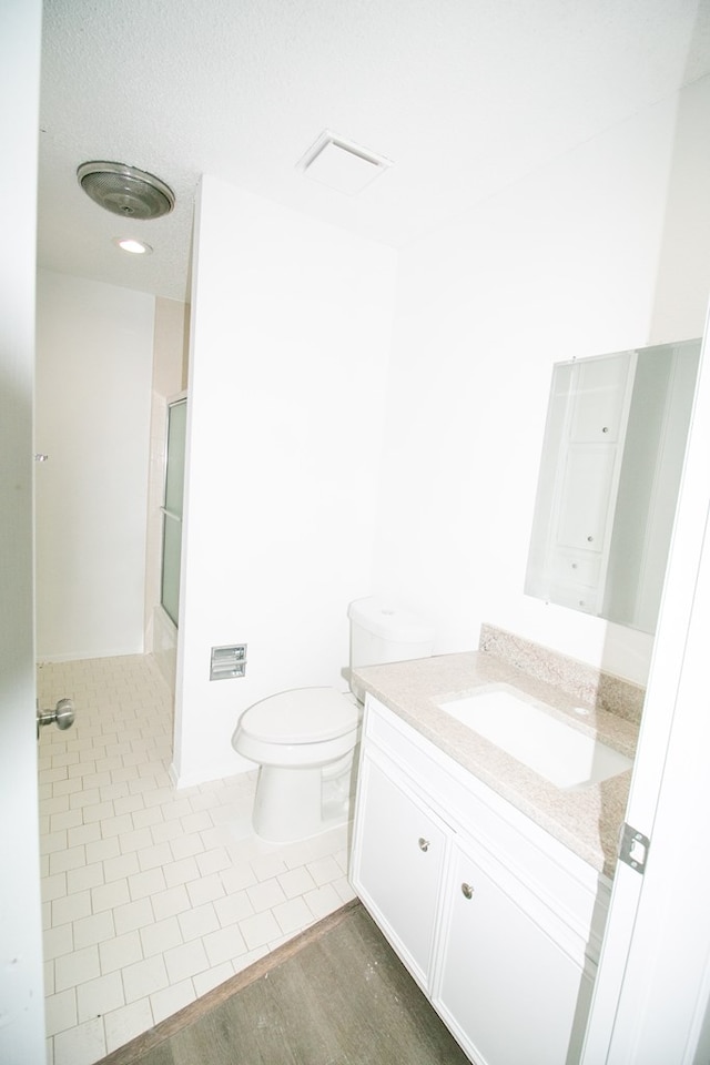 bathroom featuring vanity, toilet, and wood-type flooring