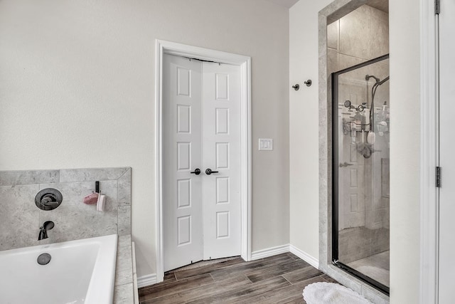 4107 Connally St, Big Spring, TX 79720 - full bath with a bath, a stall shower, and wood finished floors