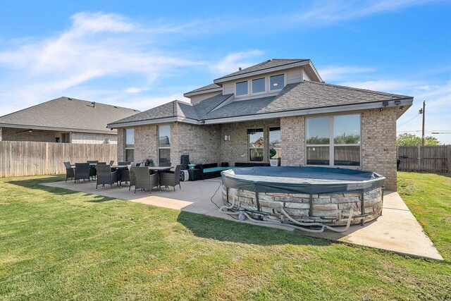 4107 Connally St, Big Spring, TX 79720 - rear view of property featuring a fenced backyard, brick siding, a patio area, and roof with shingles