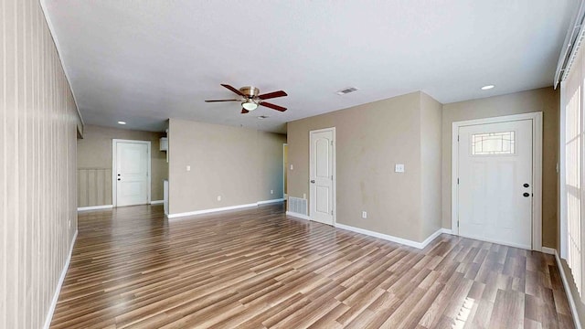 unfurnished living room with light hardwood / wood-style flooring and ceiling fan