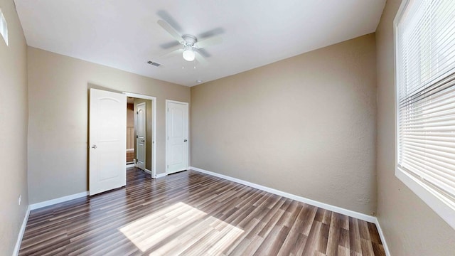 unfurnished bedroom with ceiling fan and dark hardwood / wood-style floors