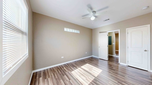 unfurnished bedroom featuring ceiling fan and dark hardwood / wood-style floors